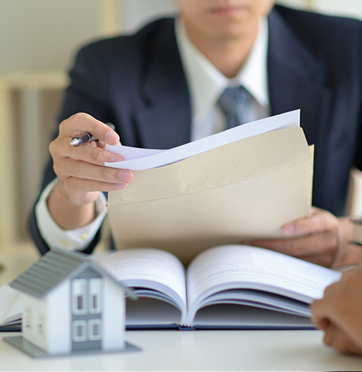 Business person reading home buying contract