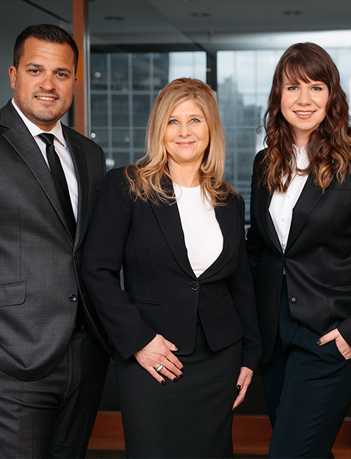 Three real estate lawyers standing in office