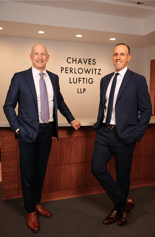 Two real estate lawyers standing at the front desk of Chaves Perlowitz Luftig LLC